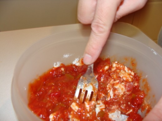 Mixing the salsa and cream cheese.