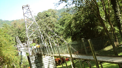 Old suspension bridge over River Mahaweli at the far end of the Garden.