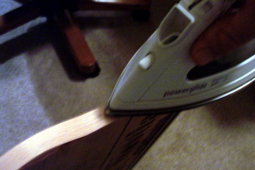 Iron the veneer strip to the front of the shelf. Makes it look like oak. Stain and varnish the veneer and exposed sides.