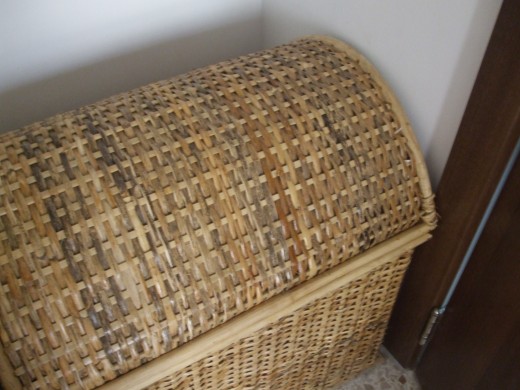 Wicker basket fitting perfectly between the wardrobe and the door.