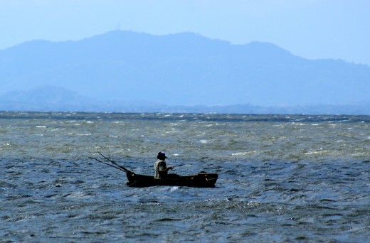 A fisherman on the west coast off Charco Verde on Ometepe Island.  His boat was leaky, I saw him bailing it out several times.