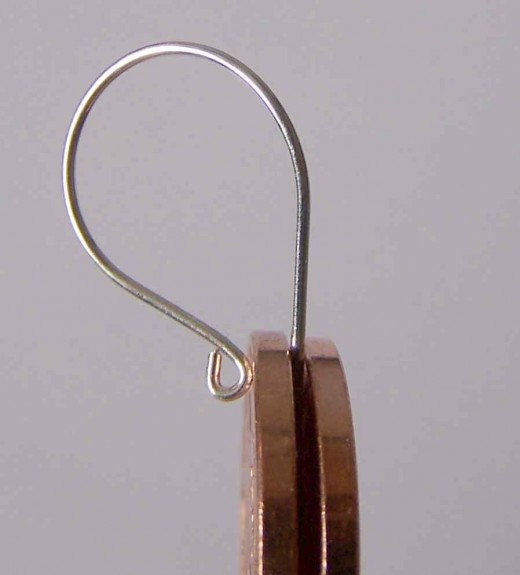 Make Your Own Earring Earwires Without Tools.   Where you want to make your bend, place this between two identical coins for grip.