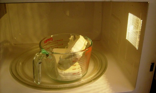 If you don't have time to wait - soften cream cheese in microwave for about 40 sec.  Be sure to remove foil first.