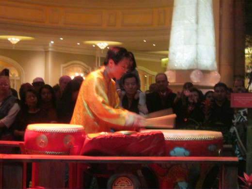 This man played a guitar type instrument, and drums as well.
