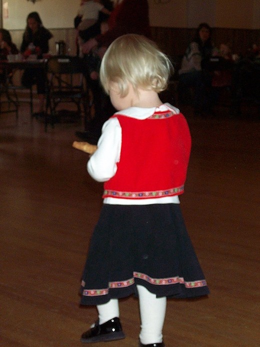Little girl running away with a krumkake, SON Christmas party 2007, Portland, OR, USA