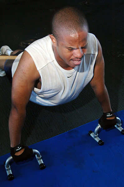 Mass Communication Specialist Seaman Matthew Patton, 21, of Oakland, Calif., performs raised pushups during a fitness enhancement program (FEP) workout in the hangar bay of USS Kitty Hawk (CV 63).