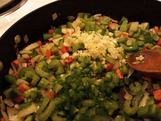 12.  When the onions are starting to brown add the garlic, jalapeno and celery.  Stir the ingredients a bit and transfer to the stew pot.