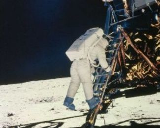 Neil Armstrong prepares to step onto the moon.  "That's one small step for man, one giant leap for mankind." 
