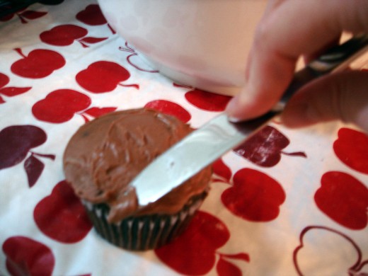 Frosting the cupcakes.