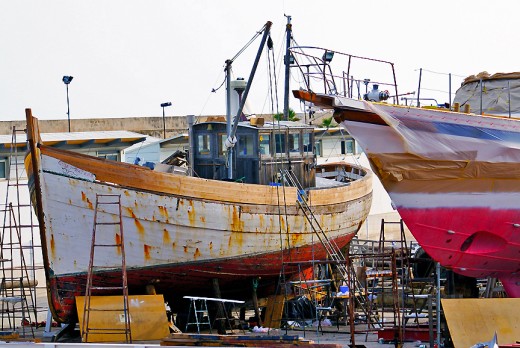 One of the wooden fishing boats that are being worked on in the boatyard