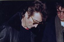 a photo of John autographing for Chapman hours before his murder