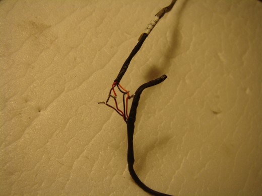 Webcam wires soldered before wrapped by tape.