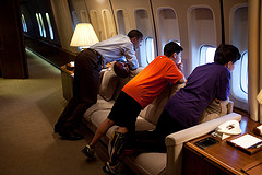 President Obama (in white shirt) and friends gaze out the window of Air Force One. What a view that must be.