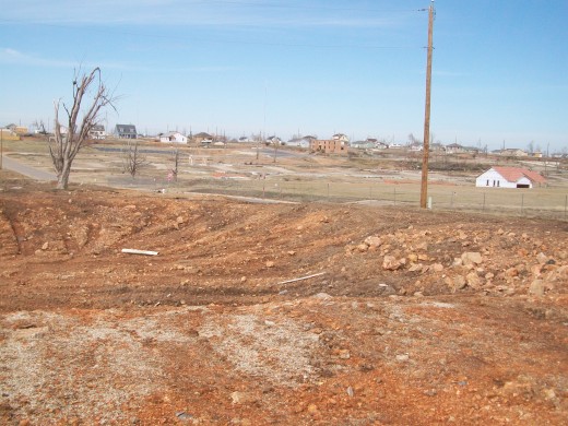 A mixed landscape of rebuilt and cleared buildings.