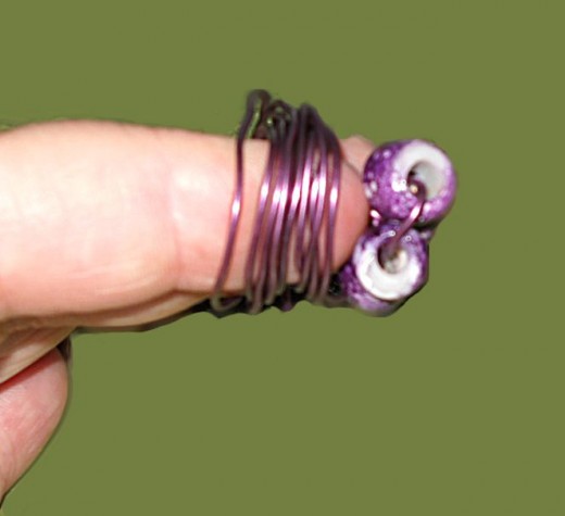 twist wire around fingers as shown but reserve several inches 