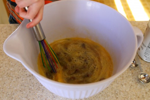 Mix the wet ingredients (egg, milk, and tea-soaked raisins) in a large bowl.