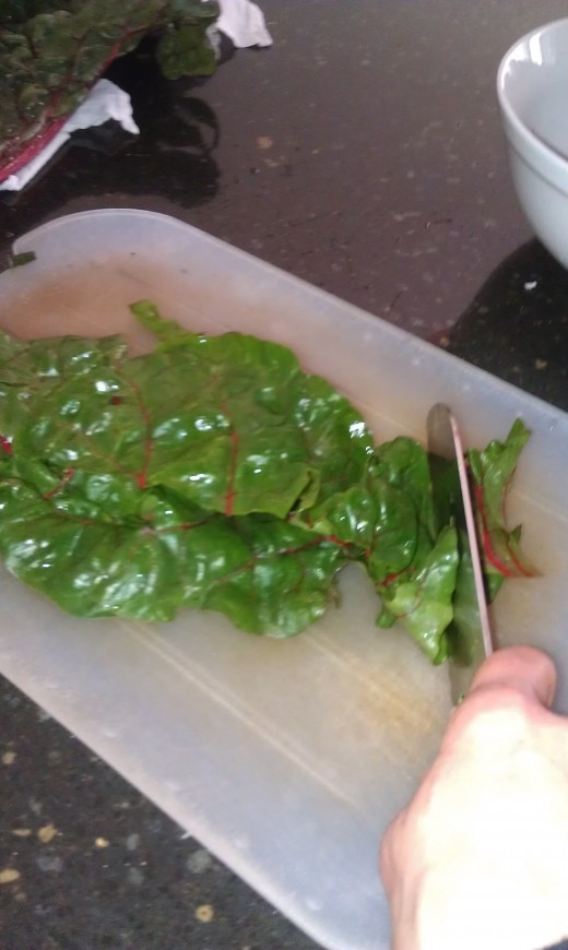 Then slice the kale or swiss chard into skinny ribbons or in chef terms it would be a chiffonade.