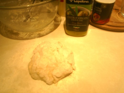 Make pizza dough with flour, baking powder, olive oil and water
