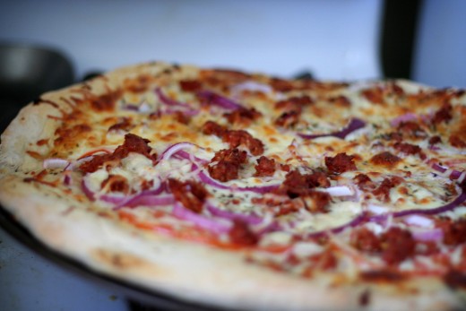 Cheese Pizza Topped with Hot Italian Sausage, Red Onion & Tomato
