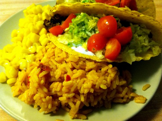 Vegetarian tacos served with Spanish rice and sweet corn