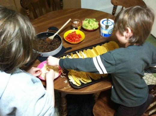 Both my children helped with assembling the tacos, here they are adding the cheese to melt in the oven