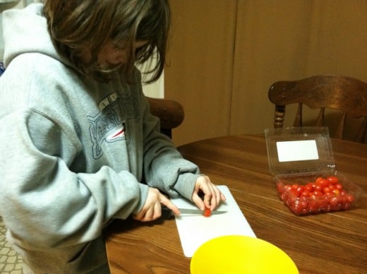 Teaching children how to safely use a knife, will help older kids be able to help with tasks like dicing tomatoes