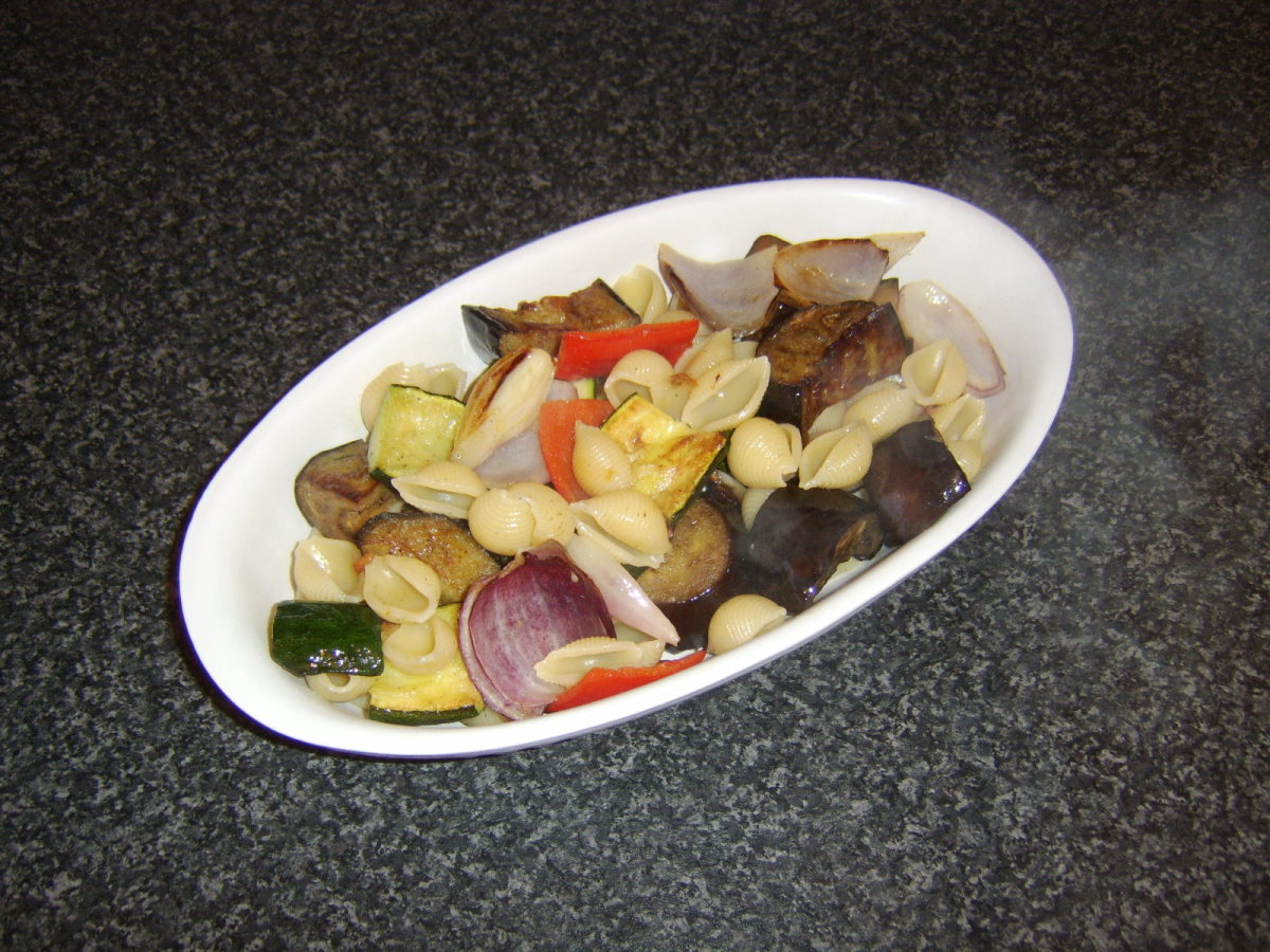 The pasta and vegetables are carefully laid in a serving dish