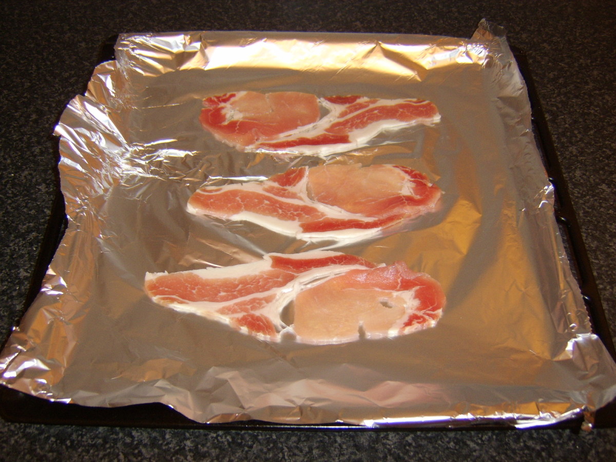 The bacon is cooked under an overhead grill