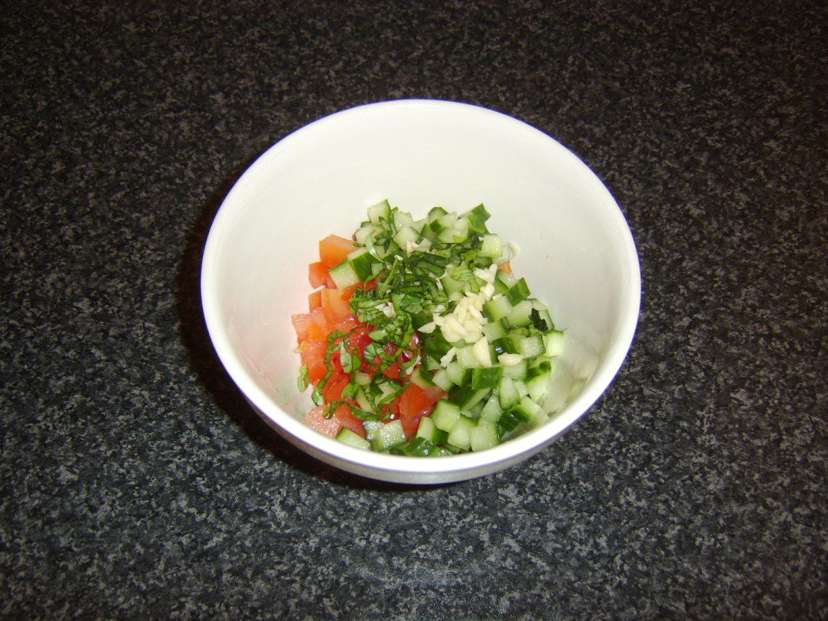 Salsa ingredients are added to a mixing bowl