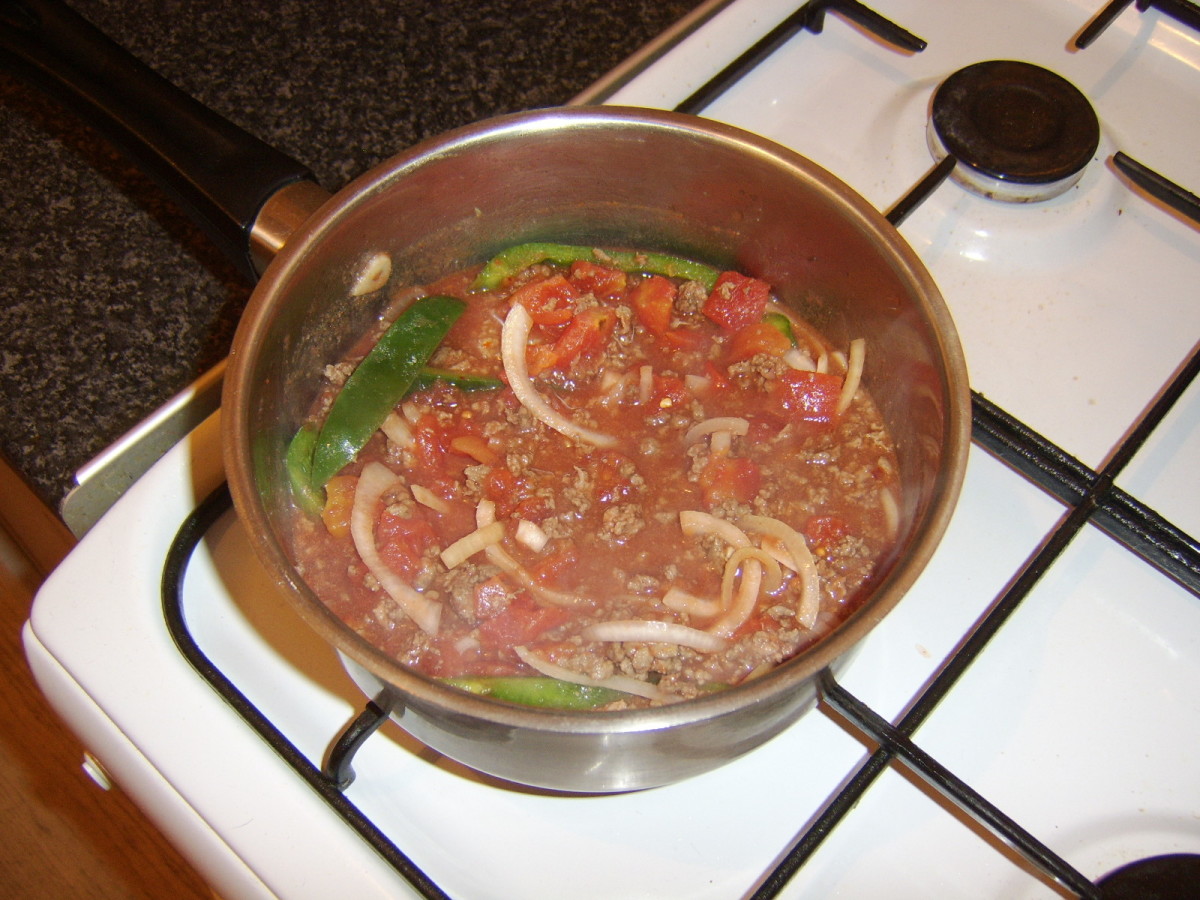Canned tomatoes are added to browned beef and sauteed vegetables