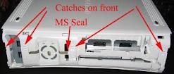 unfasten clips on front of machine