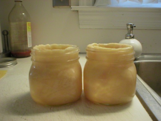 Lining jars with dough.