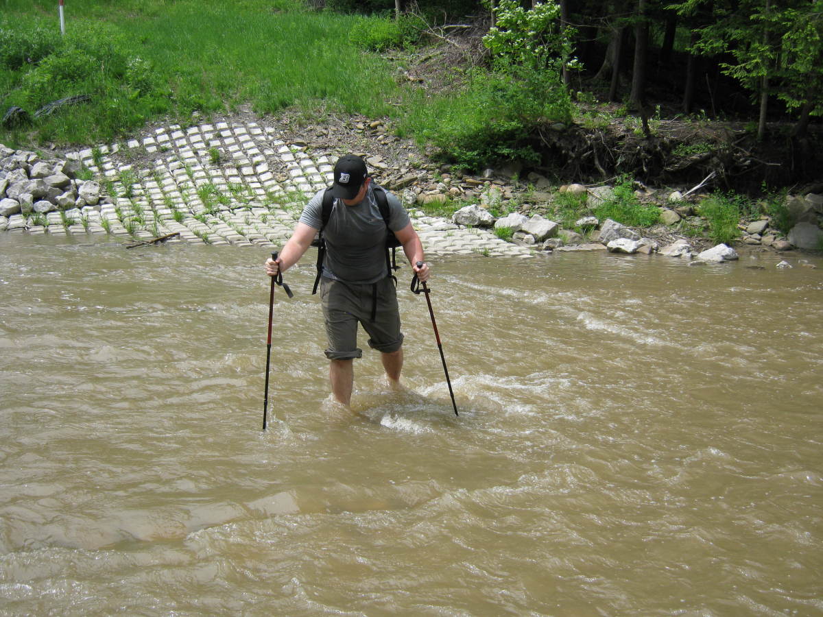 Use trekking poles to reduce stress on knees and stabilize yourself in rough terrain.  They are also great for stream crossings like this.   