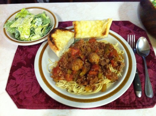 Spaghetti and meatballs with cheesy garlic bread and salad.
