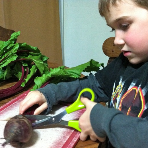 Using kitchen scissors, cut the stems of the beets. Tip: don't cut too close to the beet or the color will bleed.