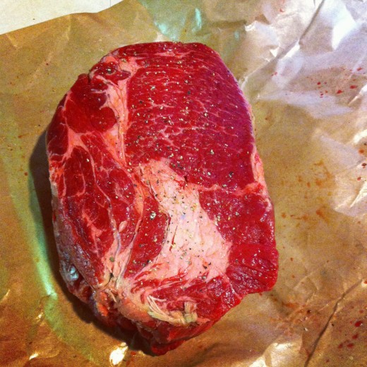A beef chuck roast, the preferred cut of beef for classic pot roast. Here, seasoned with kosher salt and fresh ground pepper.