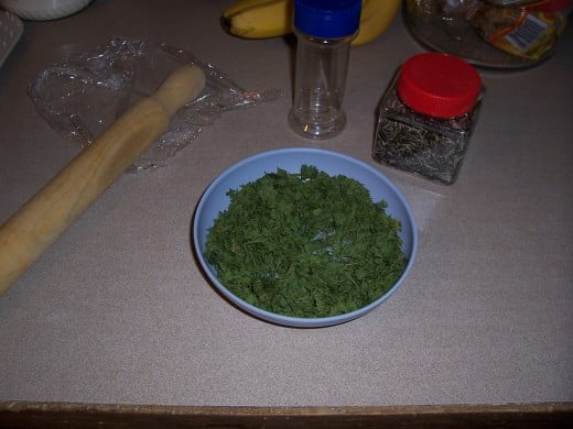 Dried parsley ready to "crunch" and place in a recycled herb bottle.