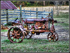 AN ANTIQUE TRACTOR SITS SILENT AFTER GIVING ITS OWNER ITS LIFE FOR SEVERAL CROPS, AND US, MANY THANKSGIVING MEALS WITH OUR FAMILIES.