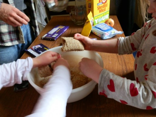 kids busy breaking up the shredded wheat