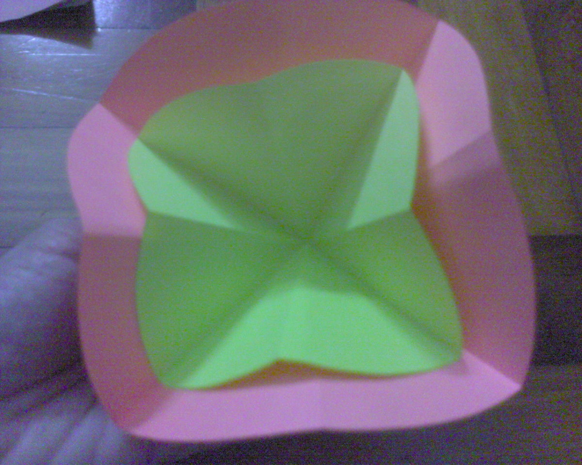 put the yellow paper into the middle of pink paper