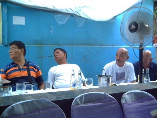 Elderly men outside the home where the Pasyon ni Kristo is being sung (Photo by Travel Man)