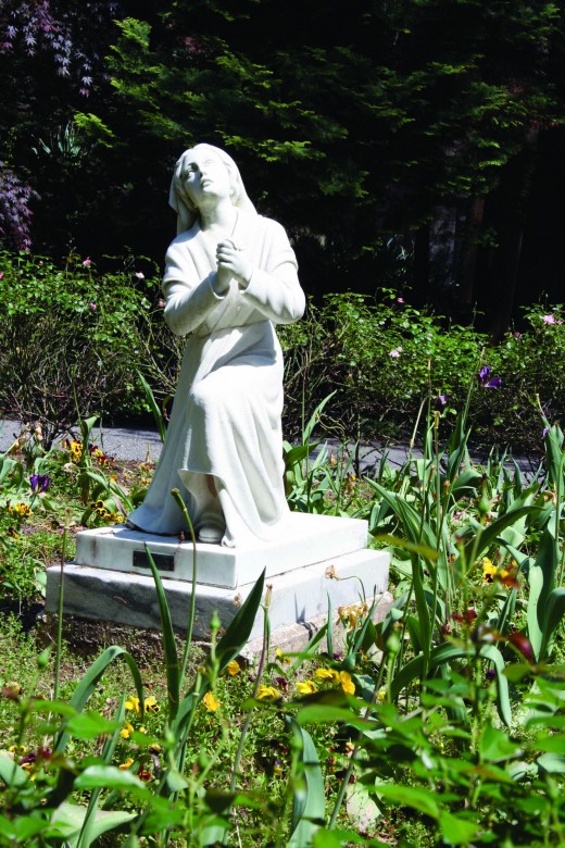 Statue of St. Bernadette near Grotto of Lourdes.