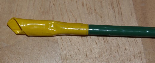 The yellow tape used for the center of the rose applied to the dowel.