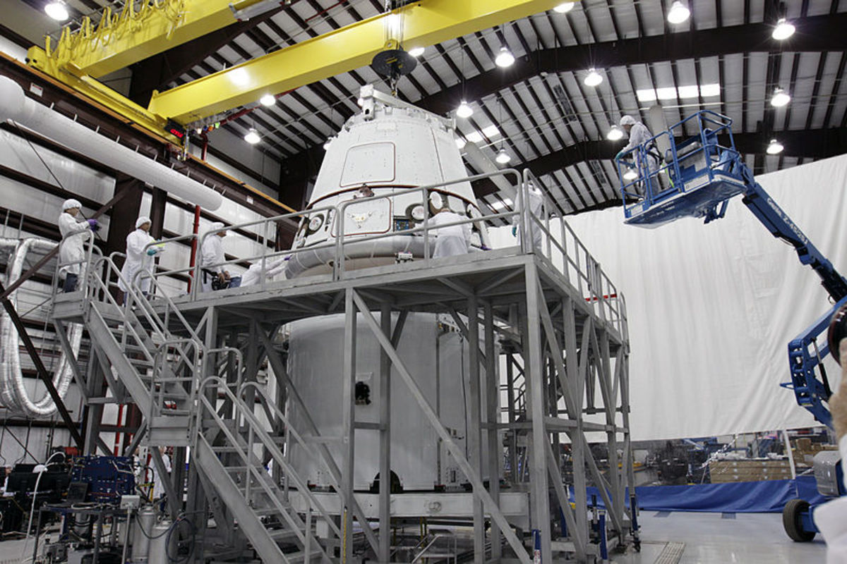 Dragon capsule atop its cargo ring inside a processing hangar at Cape Canaveral Air Force Station on Nov. 16, 2011 before a successful demonstration flight for NASA COTS.