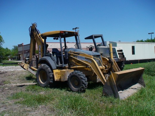 Combination bulldozer and back hoe.