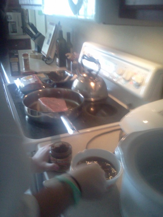 My daughter prefers not to have her picture taken... Here she prepares the beef stock while the first side of the roast sears in the skillet.