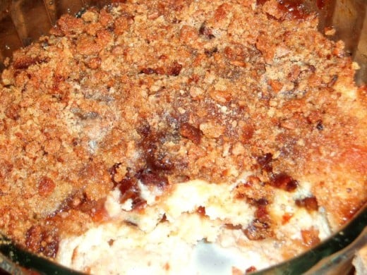 bread and butter pudding with a crunchy top of jam and breadcrumbs