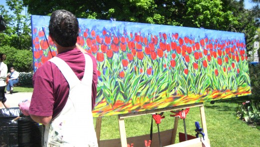 This photo was shot in Ottawa during the Tulip Festival in 2007. The artist here as you can see was painting on site. I just couldn't remember if he had some paintings displayed next to him.