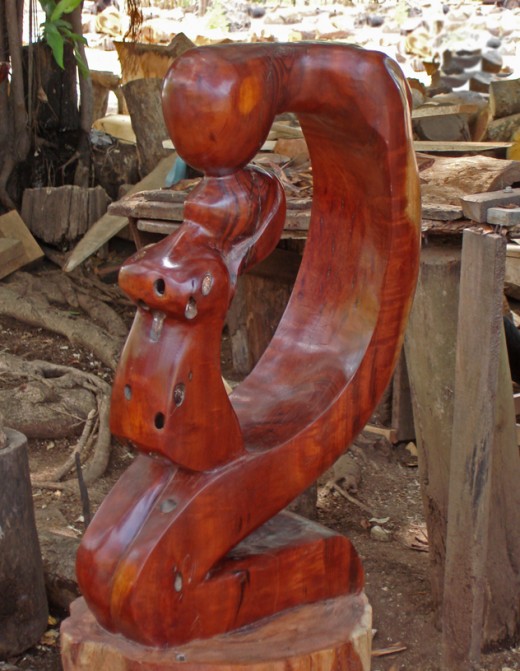 Carving of two lovers kissing.  This piece is about 3 feet tall.