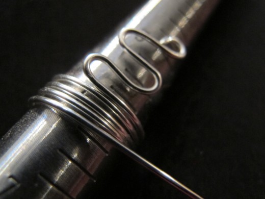 Coil the wire around the ring mandrel, wrapping it one-and-a-half sizes BELOW your desired size. Keep the coils tight and even,